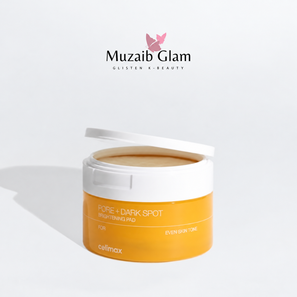 Celimax Pore + Dark Spot Brightening Pad 40 Pads with lid lifted on a white background, with Muzaib Glam logo