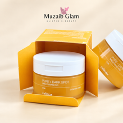 Celimax Pore + Dark Spot Brightening Pad 40 Pads jar inside its open yellow carton on a cream background